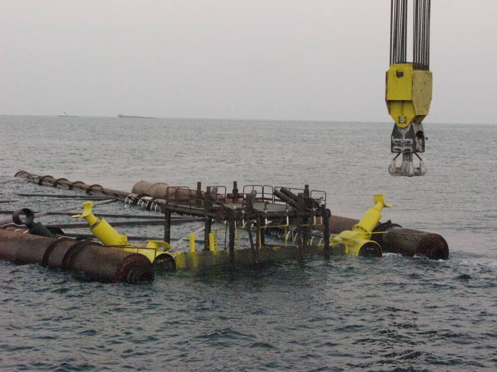 Marine structure at the water surface beneath lifting equipment