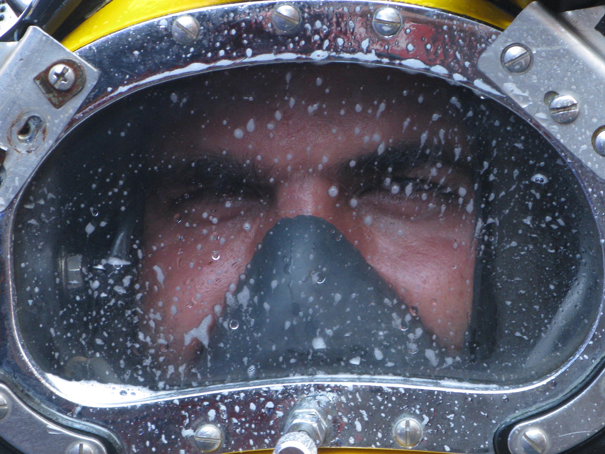 Close-up of a commercial diver wearing a diving helmet
